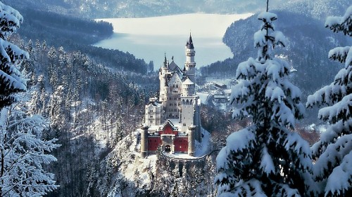 Image white and red castle on top of mountain