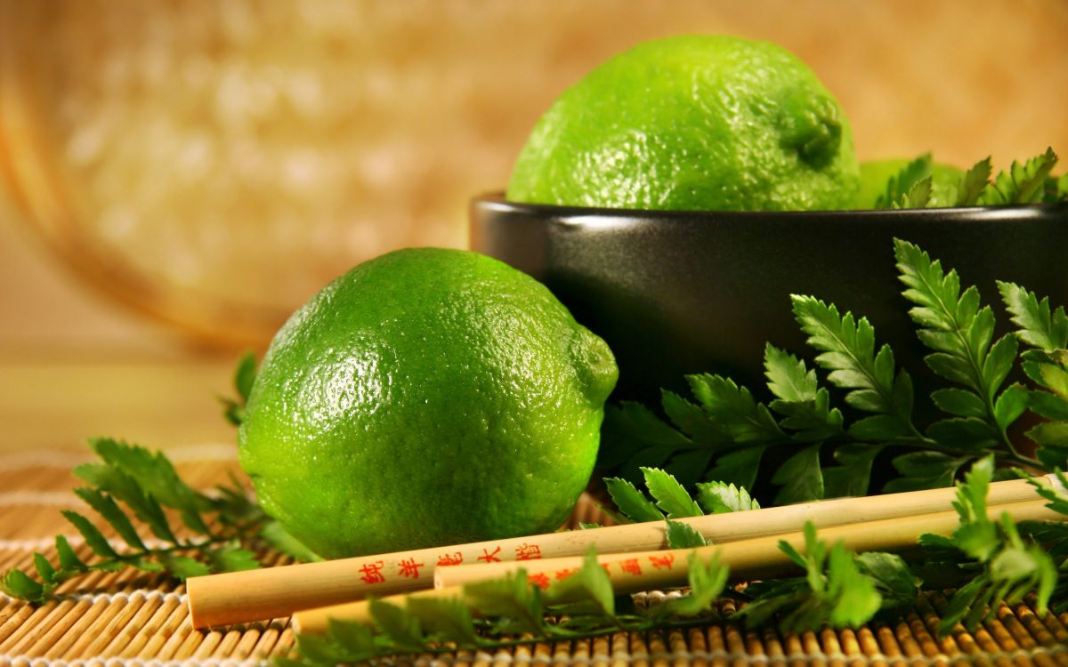 green lime fruit on brown wooden stick