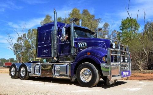 Image blue and white truck on road during daytime