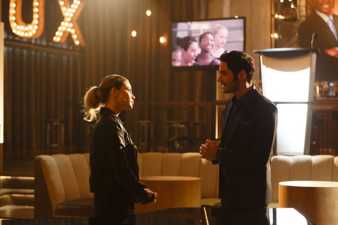 man in black suit standing beside woman in black long sleeve shirt