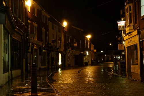 Image people walking on sidewalk near buildings during night time