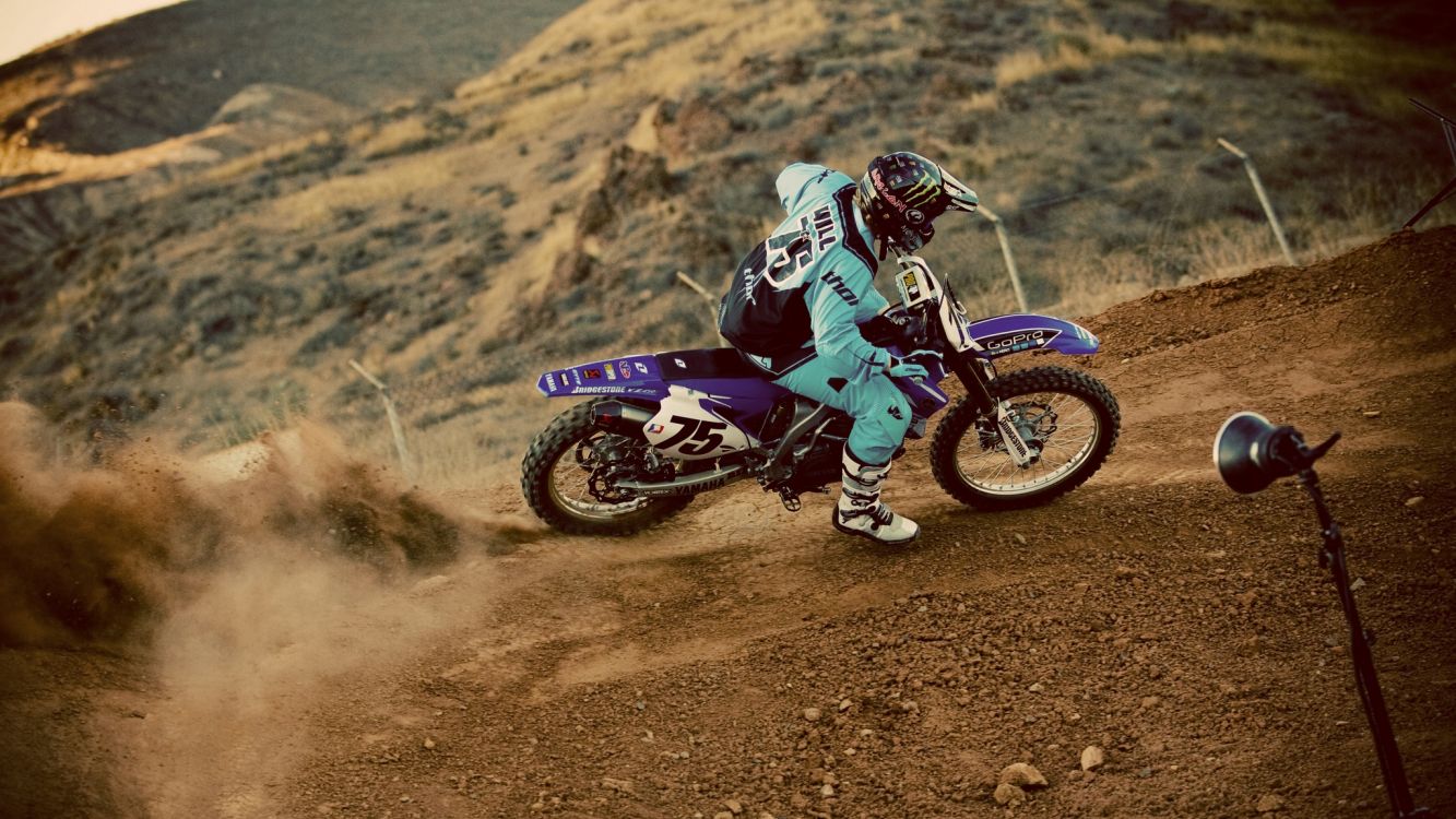 man in red and white motocross suit riding motocross dirt bike