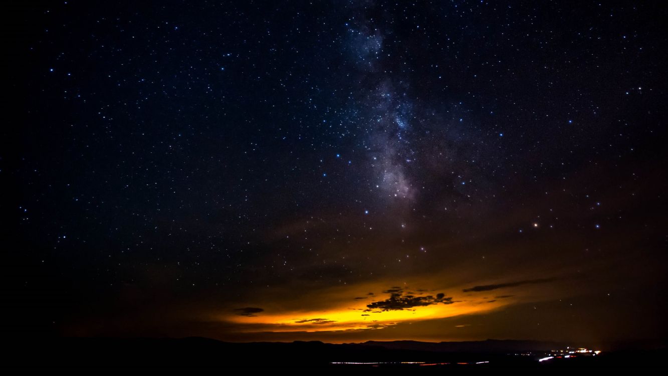 silhouette of mountain under starry night