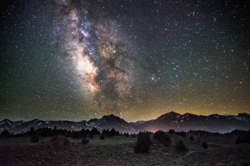 Image black and white mountain under blue sky with stars during night time