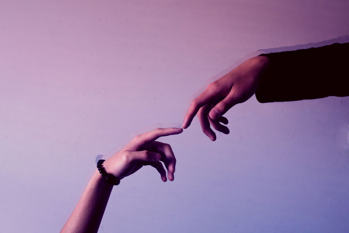 person wearing silver ring and black bracelet