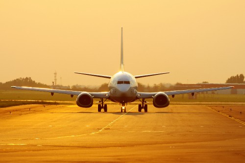 Image white airplane on brown field during daytime