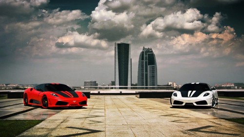 Image red and white sports car on road near city buildings during daytime