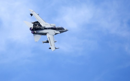 Image white and black jet plane in mid air during daytime