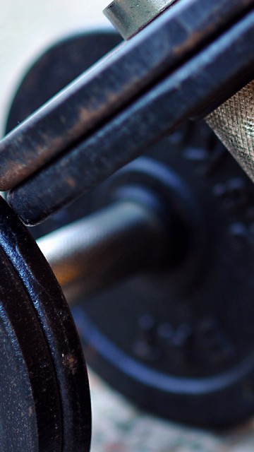 Image black and yellow dumbbell on yellow textile