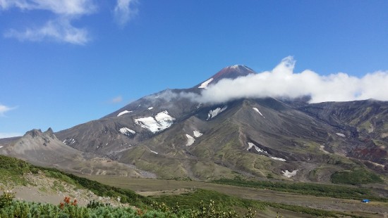 Image green and gray mountain under blue sky during daytime