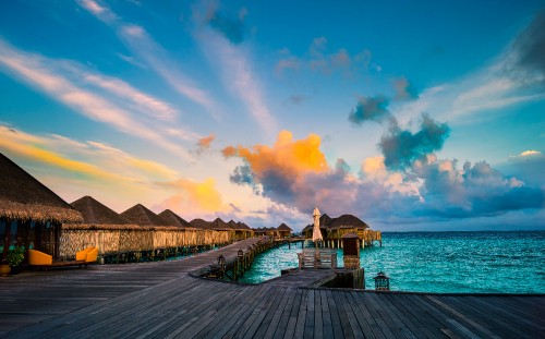 Image brown wooden dock on sea under blue sky during daytime