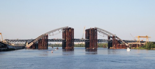 Image brown bridge over body of water during daytime