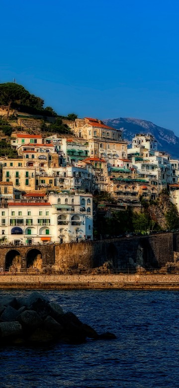 Image white concrete building near body of water during daytime