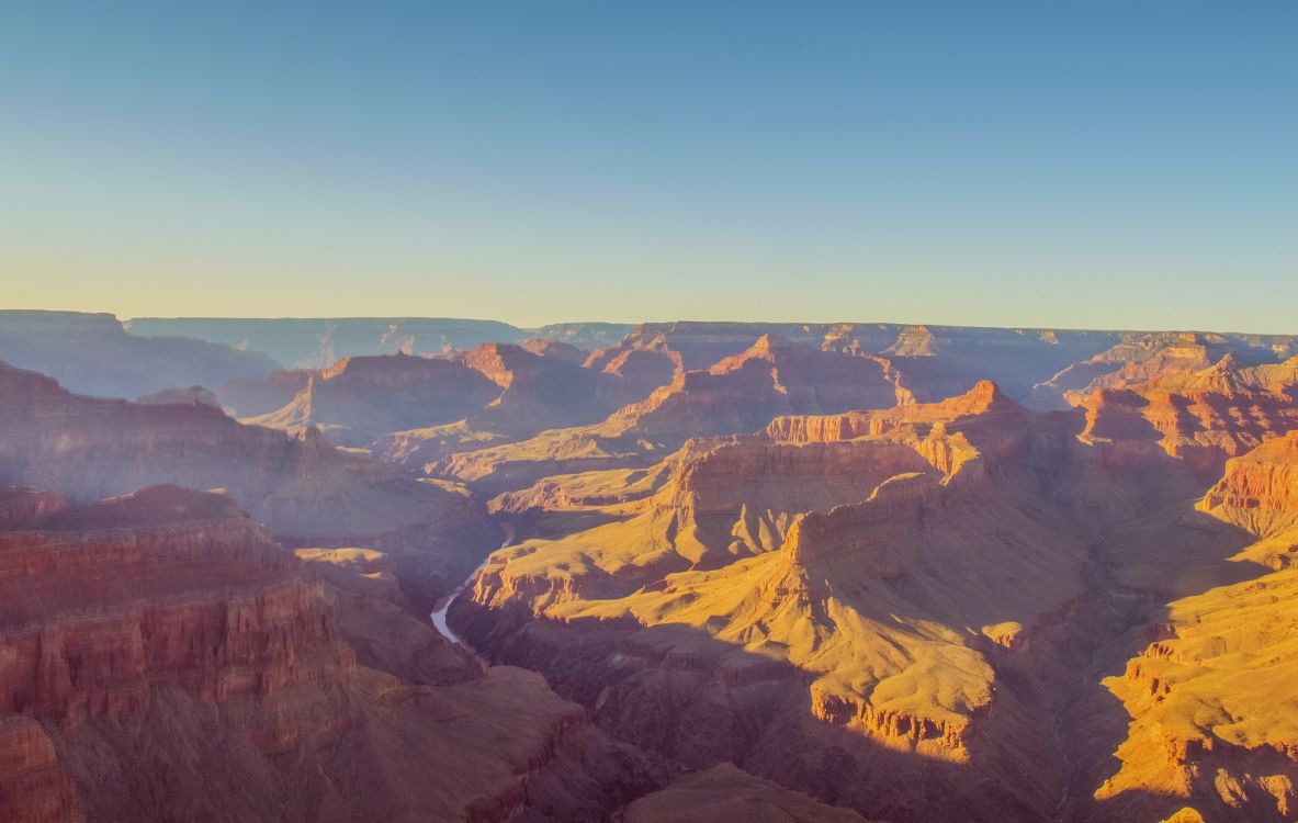 Montañas Marrones y Negras Bajo un Cielo Azul Durante el Día. Wallpaper in 2700x1711 Resolution