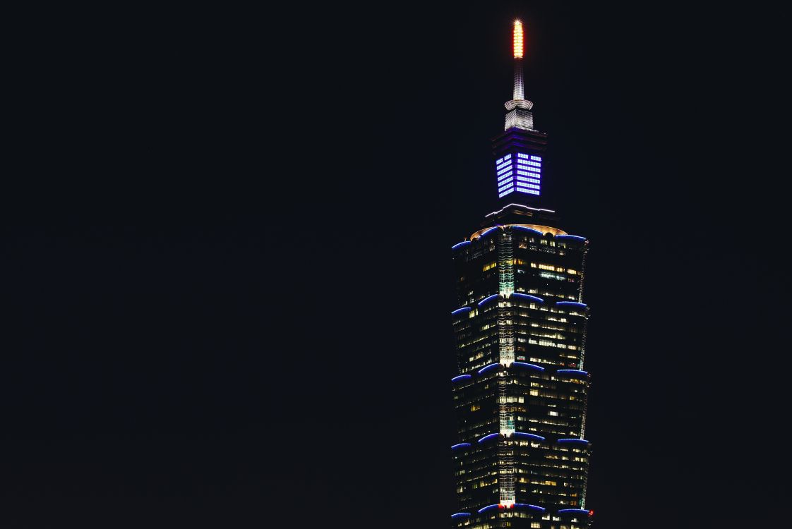 black and yellow high rise building during night time