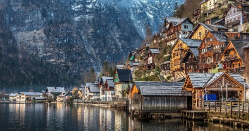 Image brown and white houses beside river during daytime