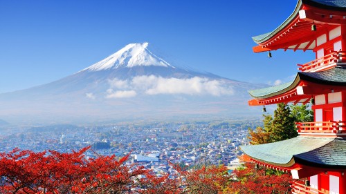 Image aerial view of city near mountain under blue sky during daytime