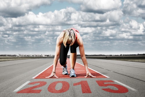 Image woman in black tank top and black shorts doing push up on gray concrete road during