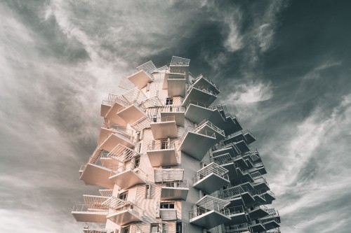 Image white concrete building under cloudy sky during daytime