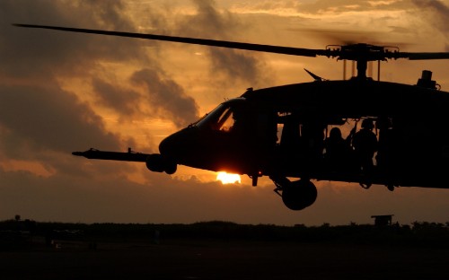 Image silhouette of helicopter during sunset