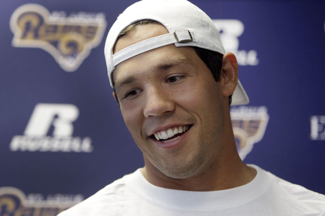 man in white crew neck shirt smiling