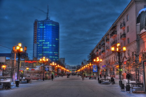 Image people walking on sidewalk near high rise buildings during night time