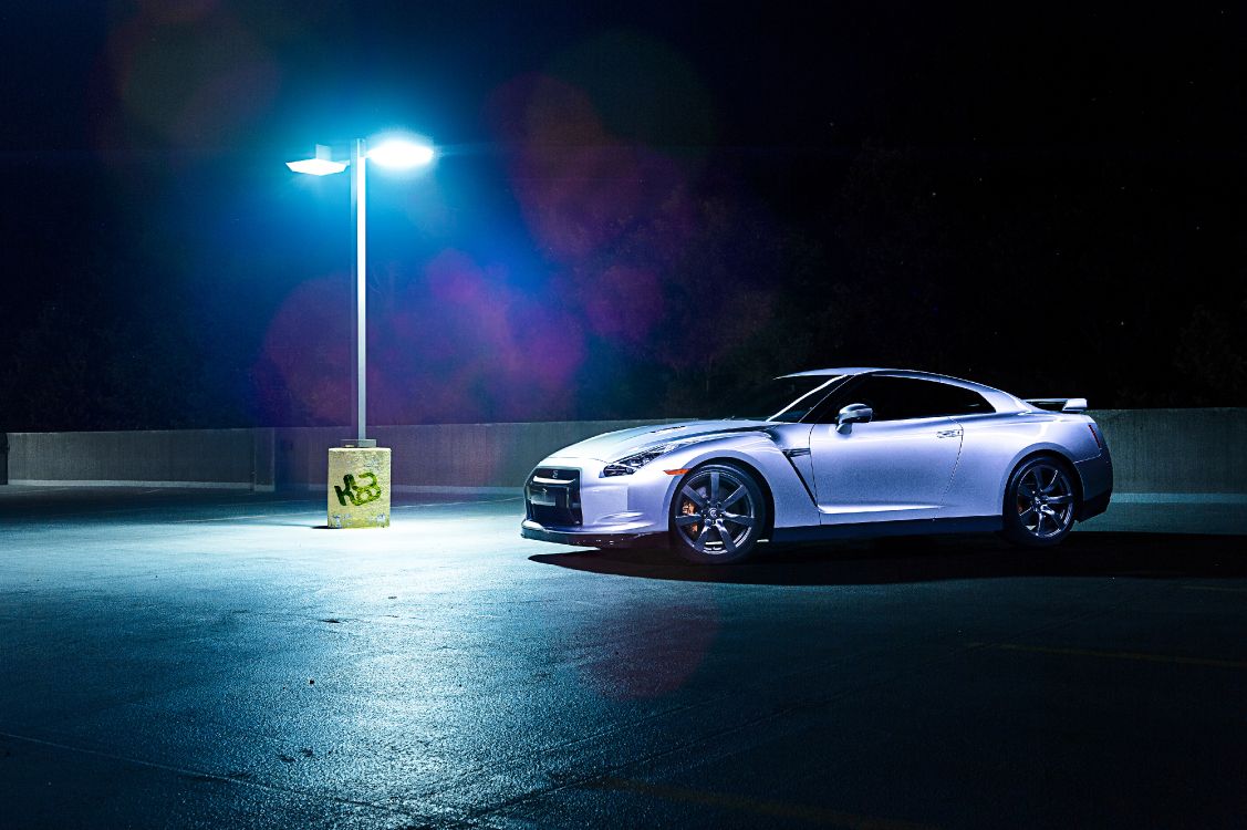 silver coupe on road during night time