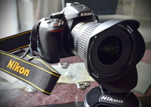 Image black nikon dslr camera on brown and black textile