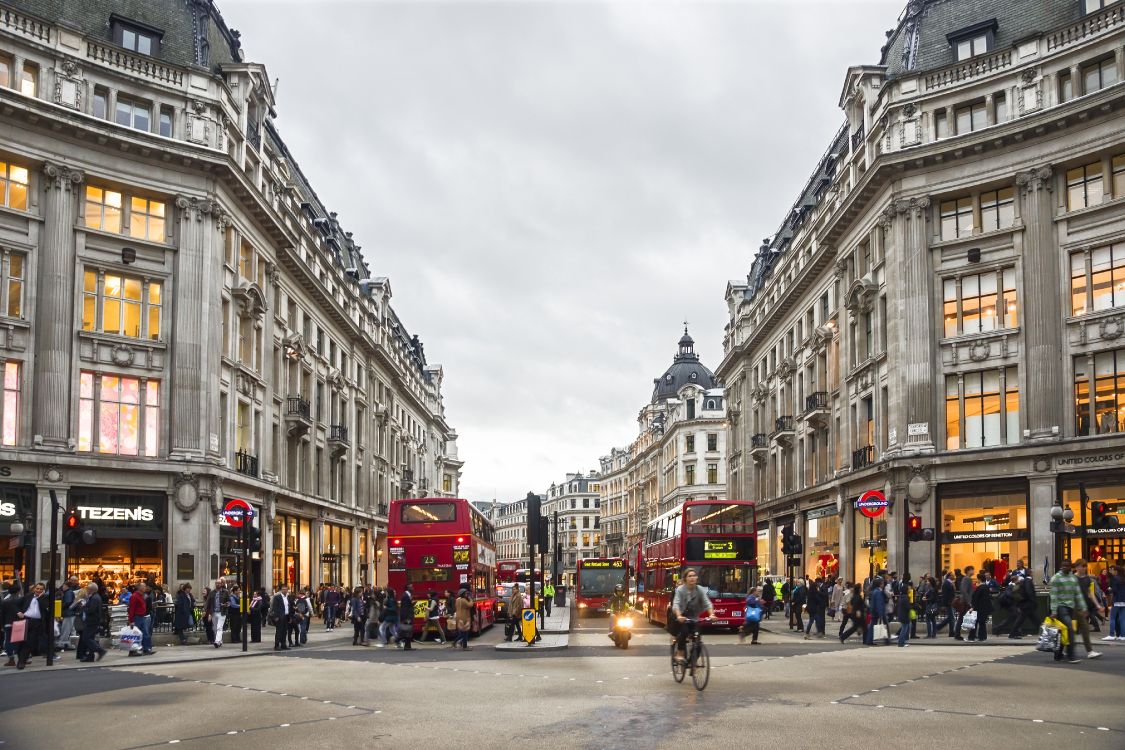 people walking on street near red double decker bus during daytime