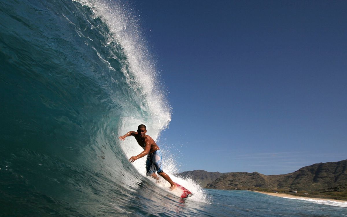 man surfing on sea waves during daytime