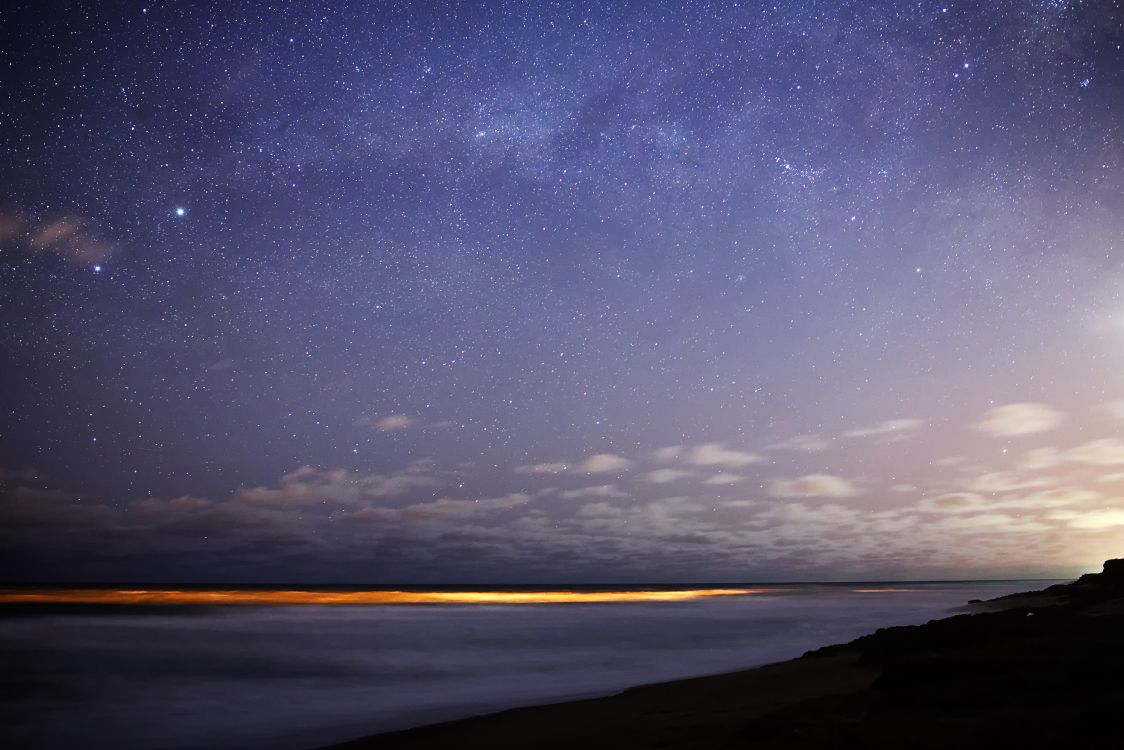 body of water under starry night