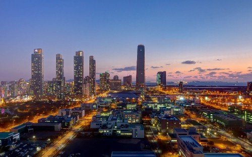 Image city with high rise buildings during night time