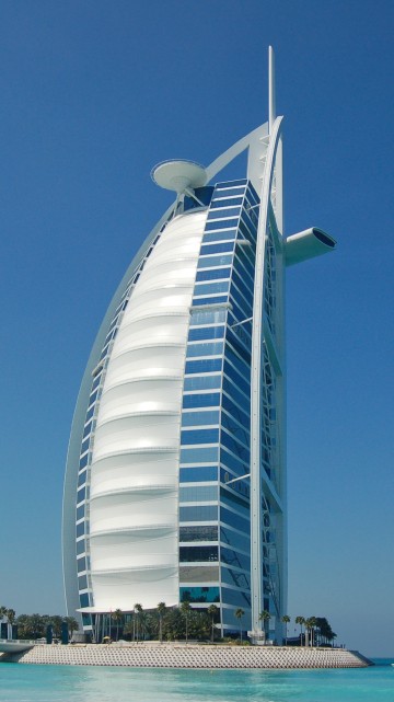 Image white and blue building near body of water during daytime