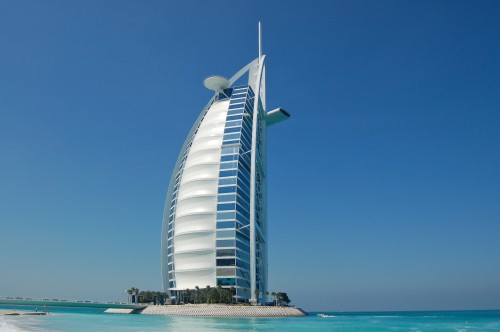 Image white and blue building near body of water during daytime