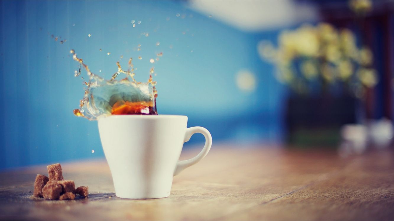 white ceramic mug with brown liquid