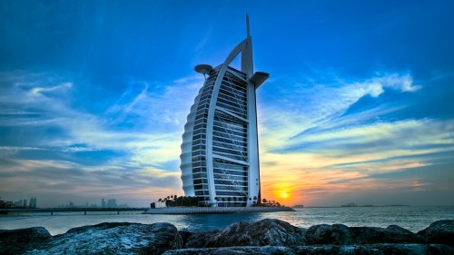 Image white and gray building near body of water during sunset