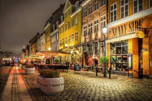 Image people walking on street near buildings during nighttime