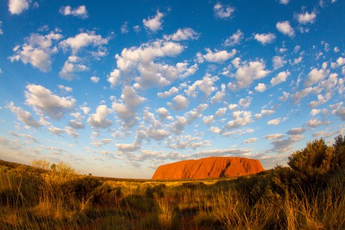 Image brown mountain under blue sky and white clouds during daytime