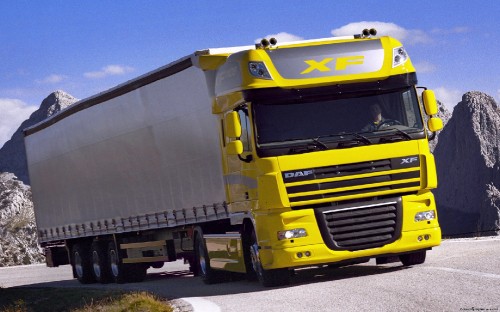 Image yellow and white truck on road during daytime