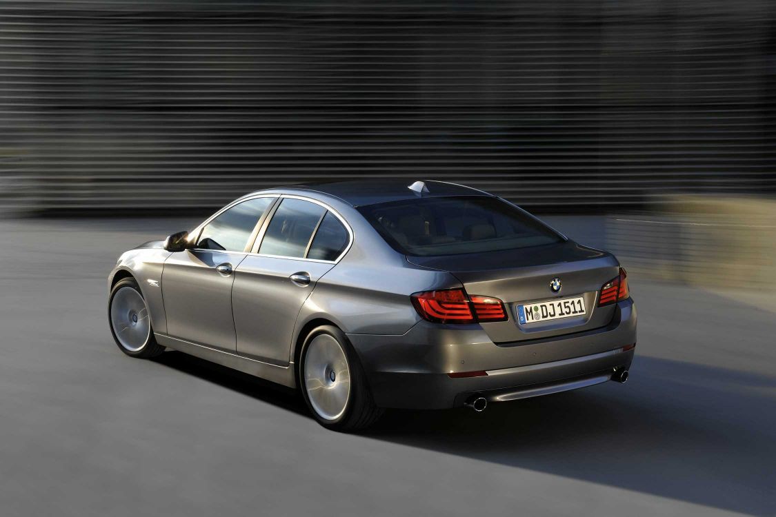 silver mercedes benz sedan parked near gray roll up door