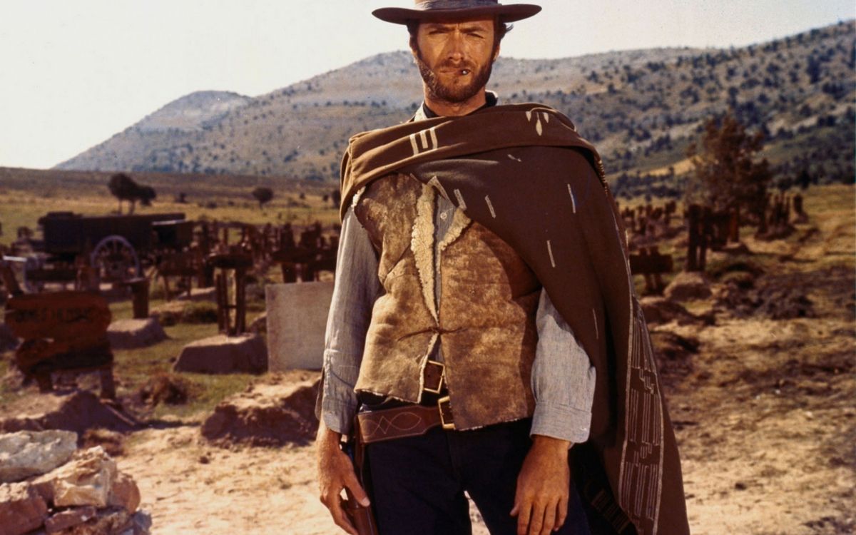 man in brown leather jacket and black pants with brown leather jacket standing on brown field