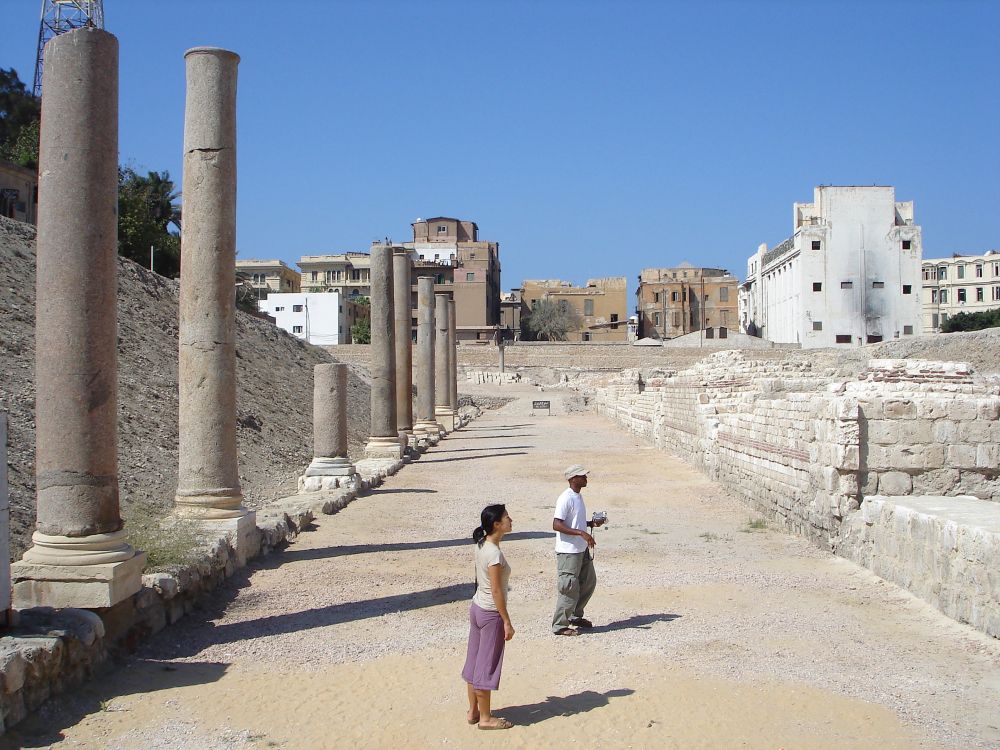 woman in white shirt walking on pathway during daytime